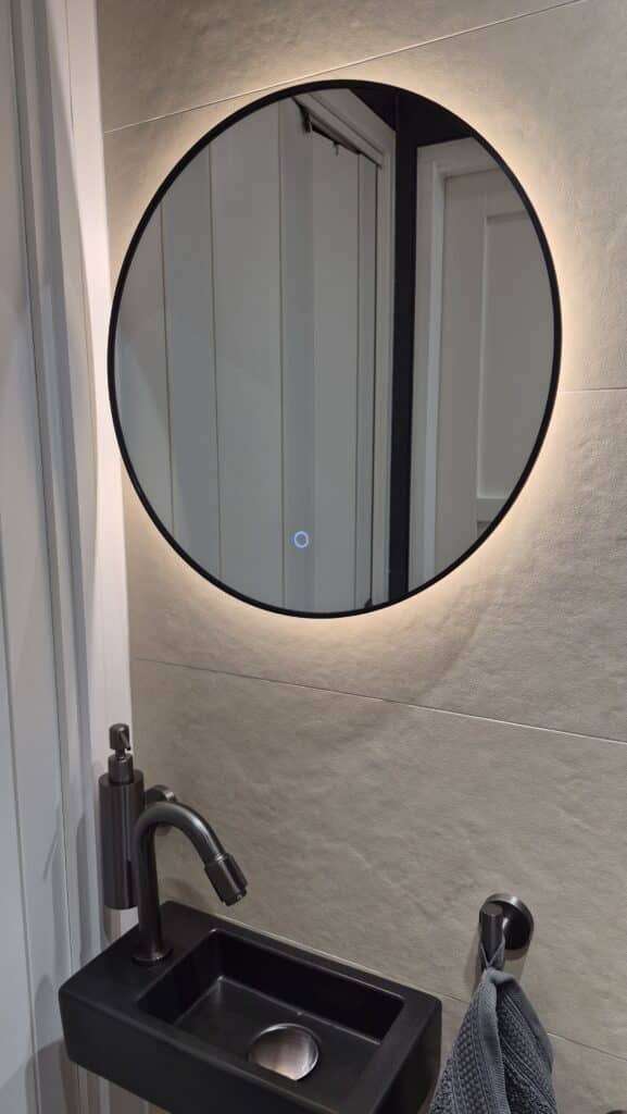 Badkamerspiegel Ilona 50×50, met zwarte lijst boven toilet fontein impressie 1